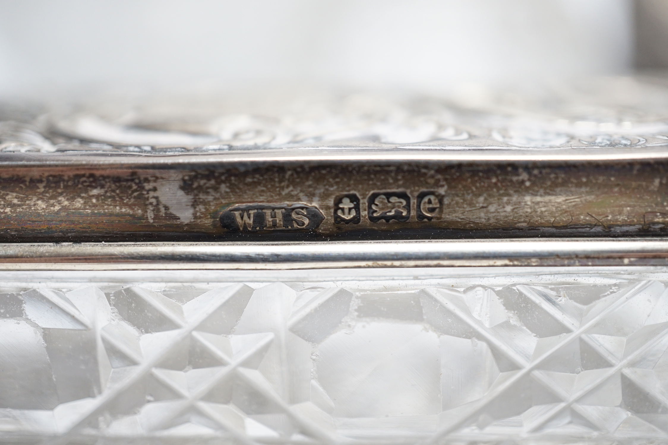 A late Victorian repousse silver mounted travelling pocket watch case, Birmingham, 1898, 11.6cm, with nickel cased pocket watch, together with five silver topped glass toilet jars.
